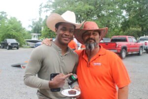 Jaylan Boudreaux and Stephen Adkins participate in Rodeo Day at Trident Construction's May Superintendent's Meeting