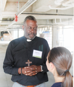 Reverend Matthew Rivers, rector of St. John's Chapel, attends Urban Land Institute's (ULI) event at Archer School Apartments, a senior living affordable housing project benefiting long-time residents of Downtown Charleston's East Side neighborhood.